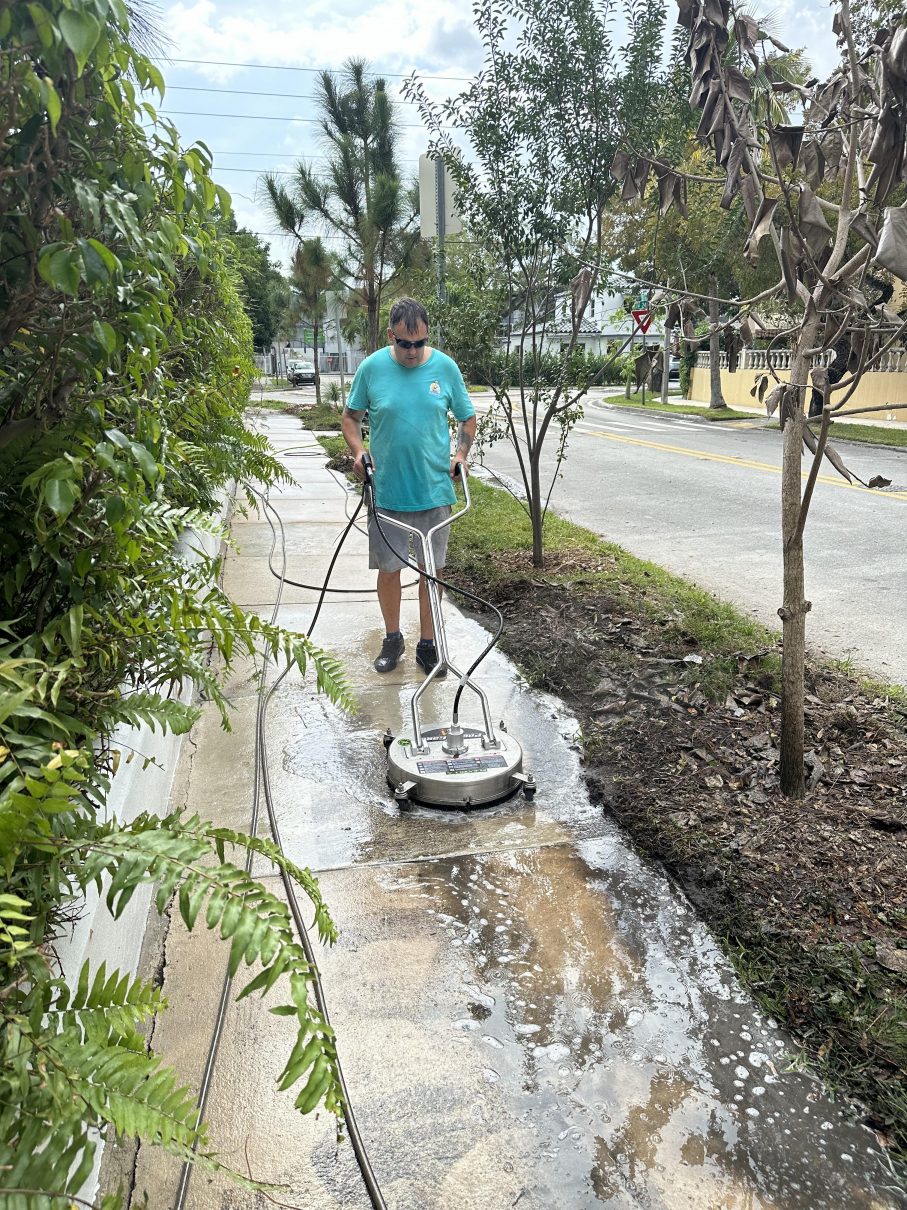Surface cleaner washing a Miami walkway with foam